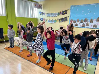 Children practicing mindful movement and breathing exercises in Kids Adventure Learning Center's yoga and mindfulness enrichment
