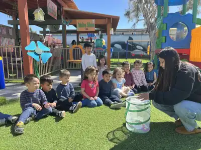 Children and teacher conducting hands-on nature experiments at the Outdoor Science Center at Kids Adventure Learning Center