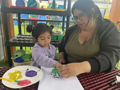 Children creating nature sculptures, murals, and eco-art projects using natural materials in an outdoor art environment at Kids Adventure Learning Center